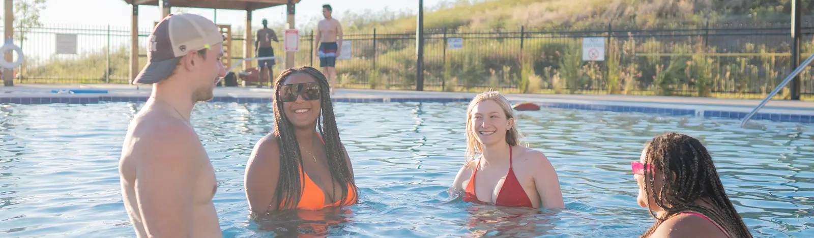 young adults relaxing in a pool